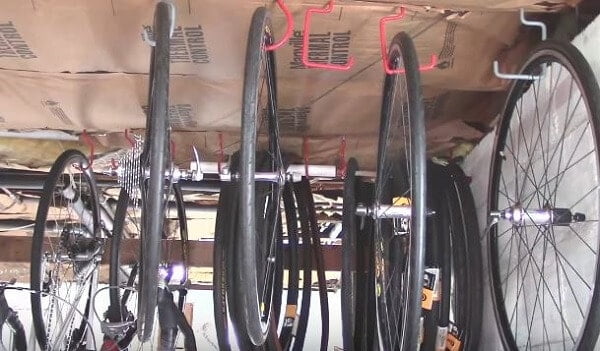Ceiling hooks for storing bike vertically in storage shed