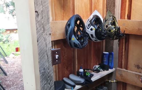 Shelves are great for storing accessories in a bicycle shed